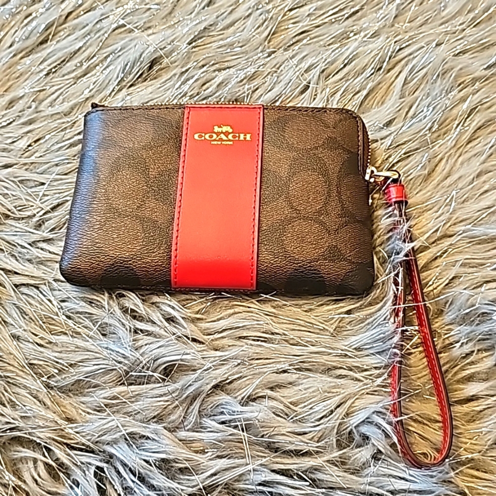 Coach Signature canvas coner zip wristlet in gold/walnut/bold red.
